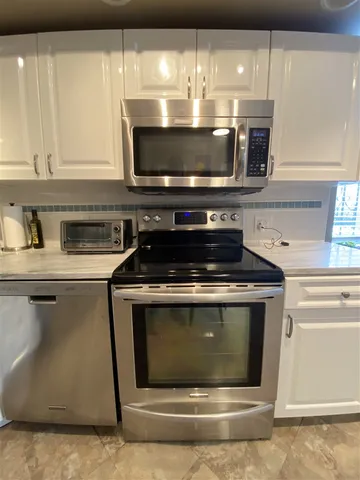 a stove top oven sitting inside of a kitchen