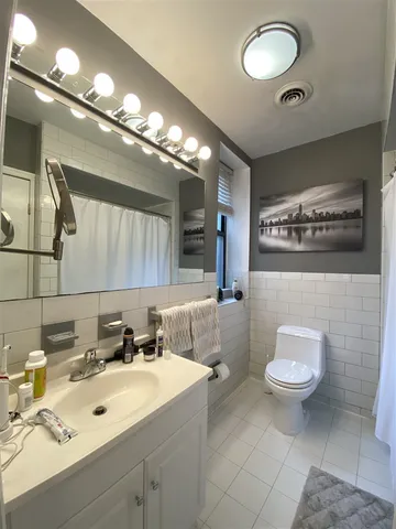 a bathroom with a sink toilet and a mirror