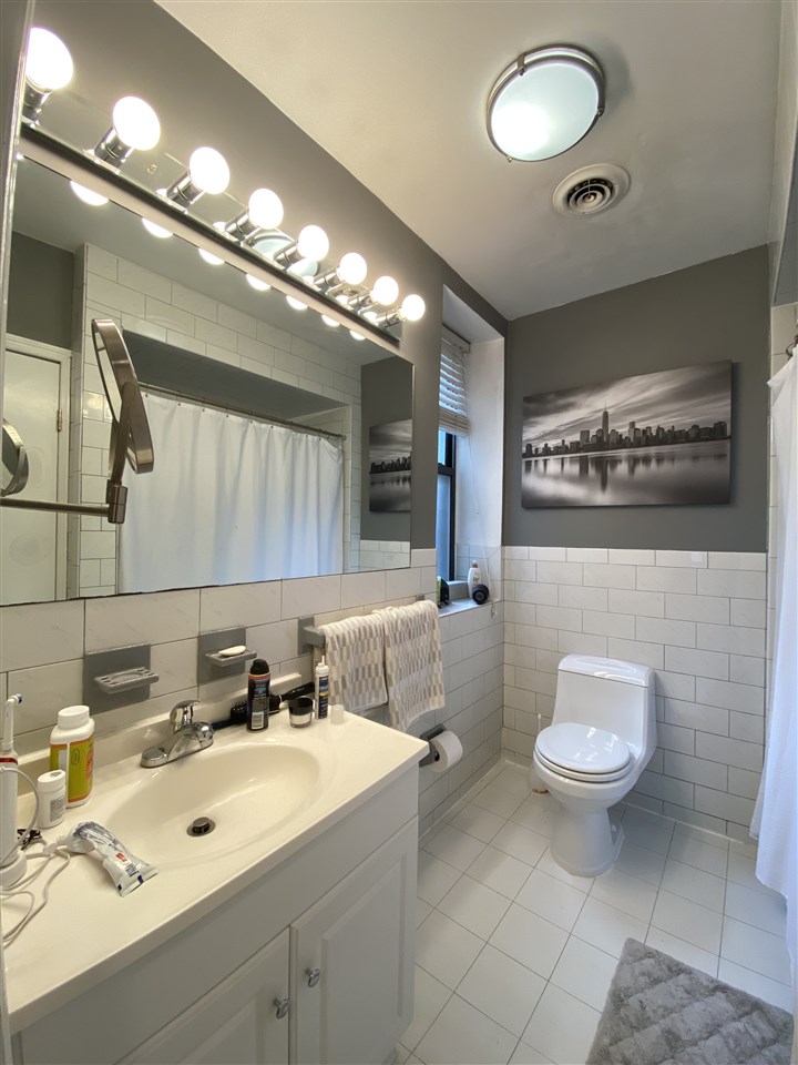 333 Monroe Street, Unit 1A Hoboken, NJ 07030 - Photo 6 of 15 a bathroom with a sink toilet and a mirror