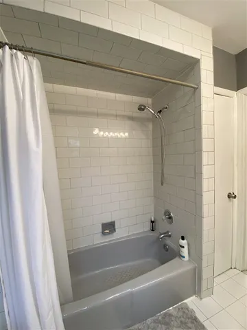 a bathroom with a bathtub and shower