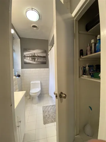 a bathroom with a toilet and a shower