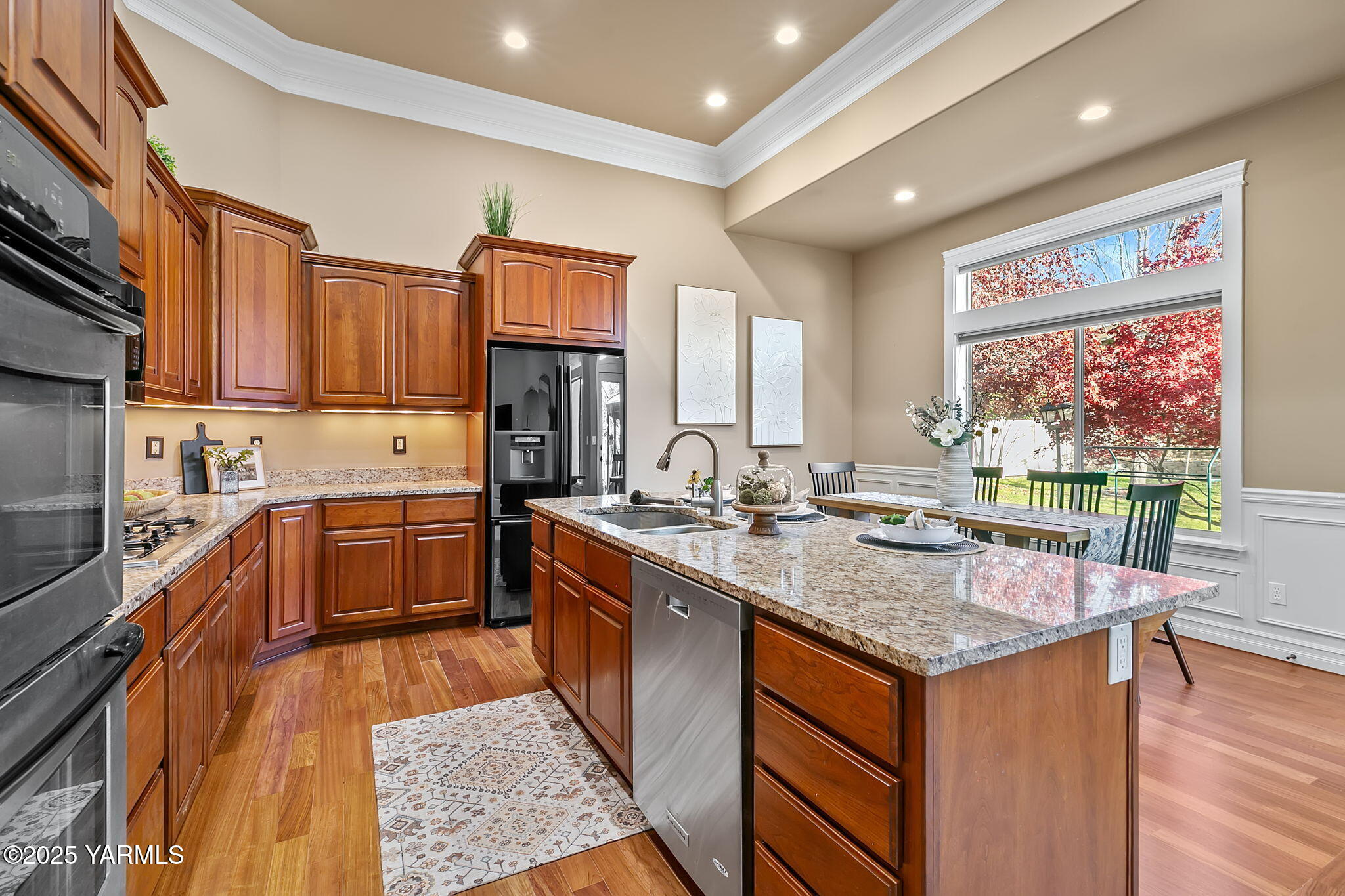 609 North 74th Avenue Yakima, WA 98908 - Photo 15 of 34 a kitchen with stainless steel appliances granite countertop a sink stove and wooden cabinets