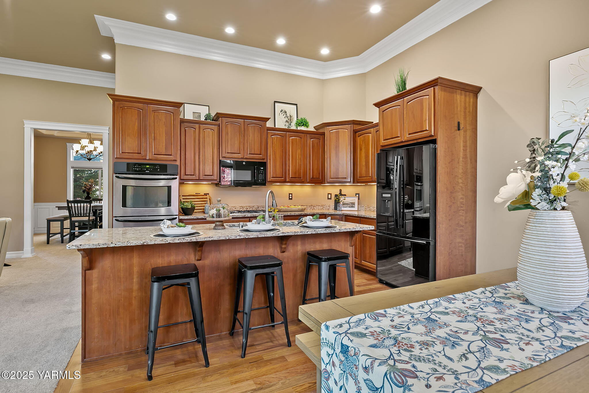 609 North 74th Avenue Yakima, WA 98908 - Photo 17 of 34 a kitchen with stainless steel appliances kitchen island granite countertop a refrigerator and a stove top oven