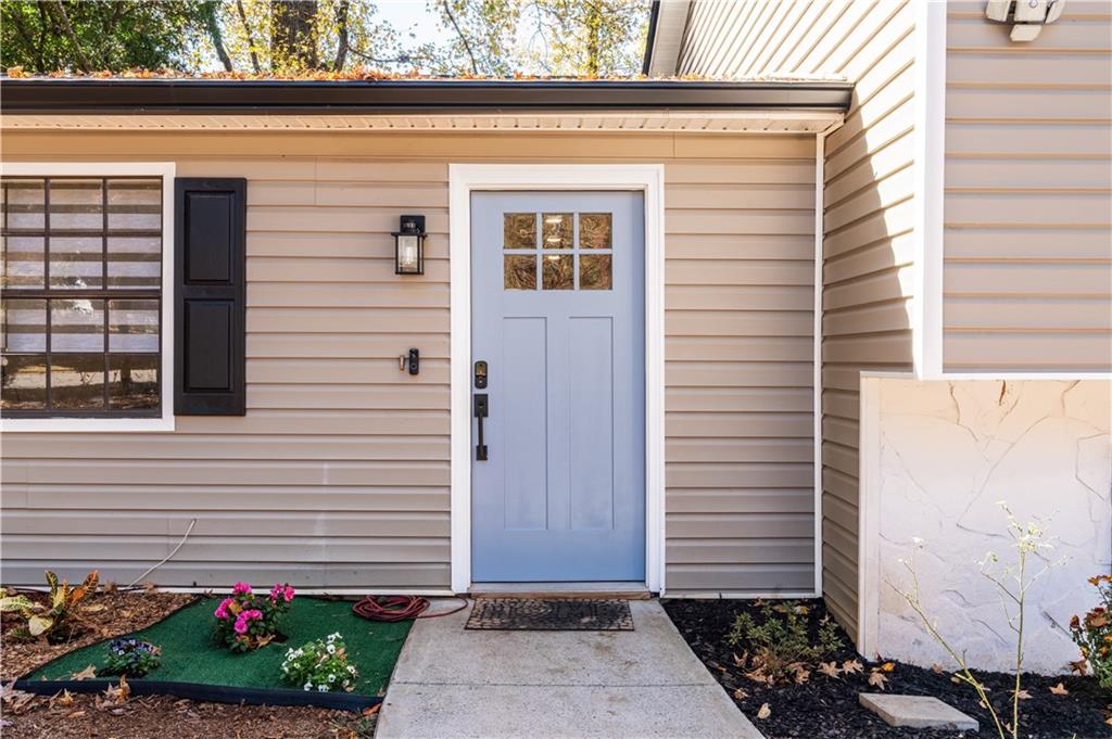 3316 Alcazar Drive Southwest Lilburn, GA 30047 - Photo 3 of 37 a front view of a house with a garden