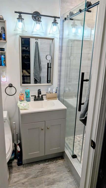 3316 Alcazar Drive Southwest Lilburn, GA 30047 - Photo 35 of 37 a bathroom with a sink a mirror a vanity and a shower