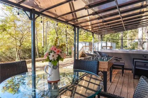 a dining room with furniture a chandelier and wooden floor