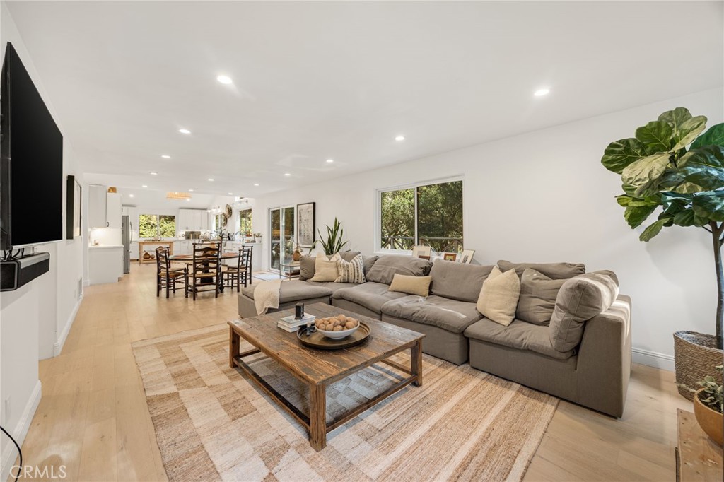 48980 De Luz Road Temecula, CA 92590 - Photo 11 of 50 a living room with furniture a flat screen tv and a potted plant
