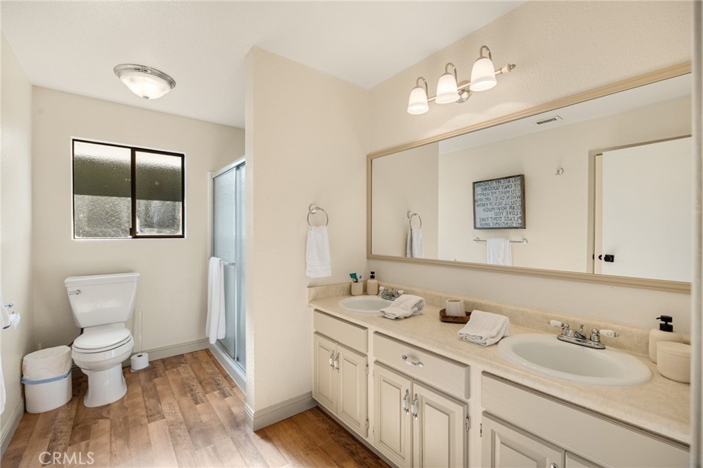 48980 De Luz Road Temecula, CA 92590 - Photo 21 of 50 a bathroom with a toilet sink and mirror