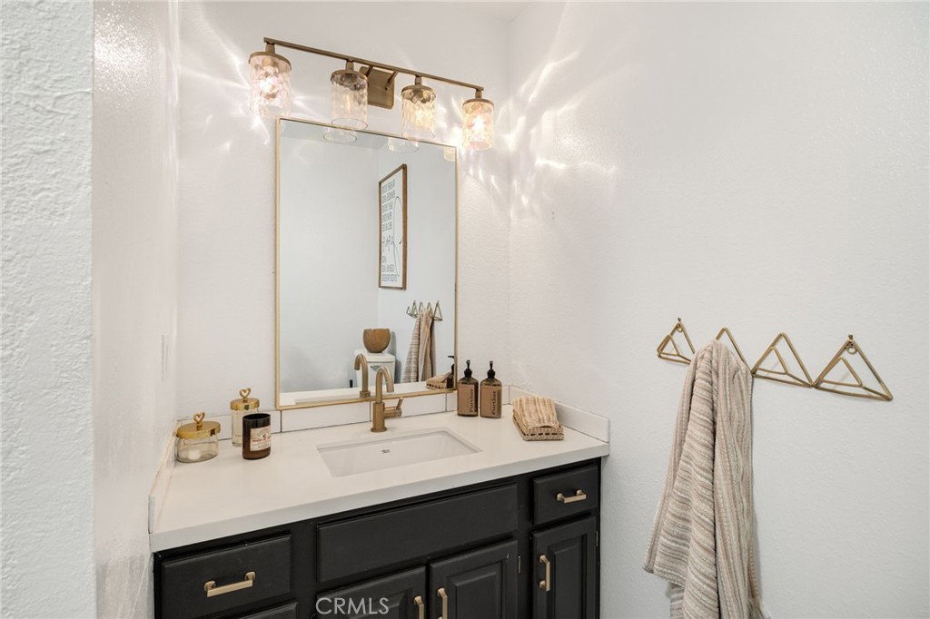 48980 De Luz Road Temecula, CA 92590 - Photo 25 of 50 a bathroom with a sink vanity and a mirror