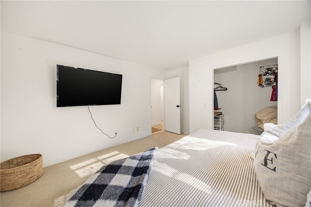 48980 De Luz Road Temecula, CA 92590 - Photo 27 of 50 a bedroom with a bed and a flat screen tv