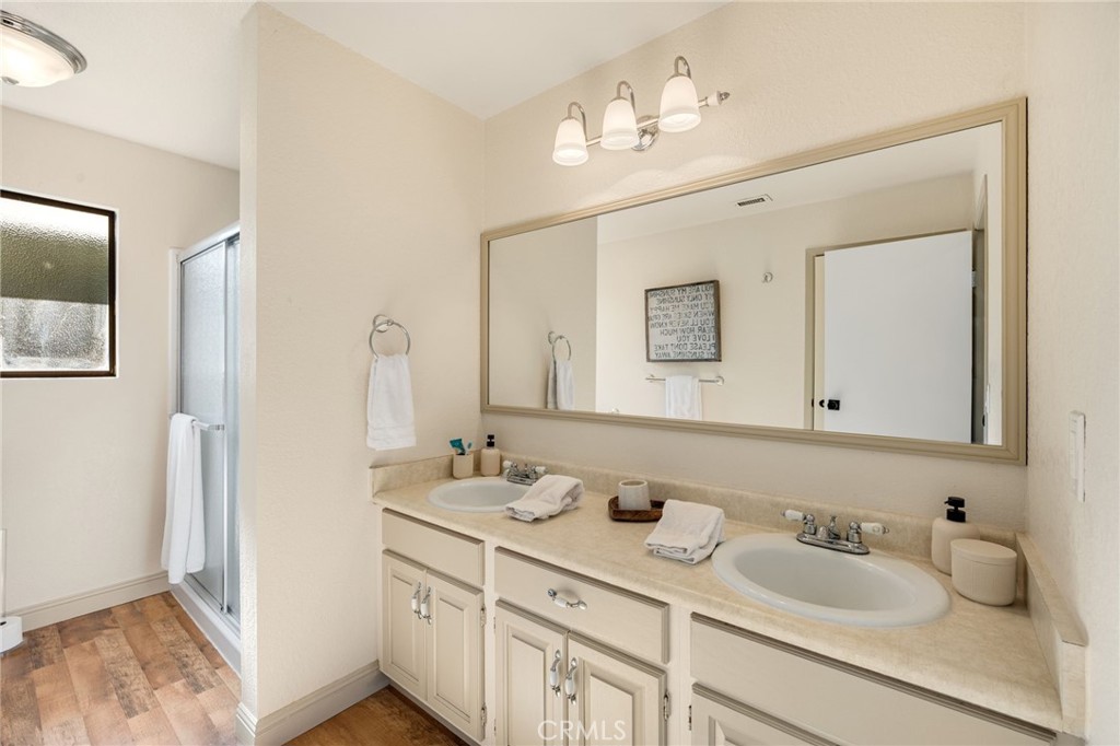 48980 De Luz Road Temecula, CA 92590 - Photo 28 of 50 a bathroom with a granite countertop sink double and mirror