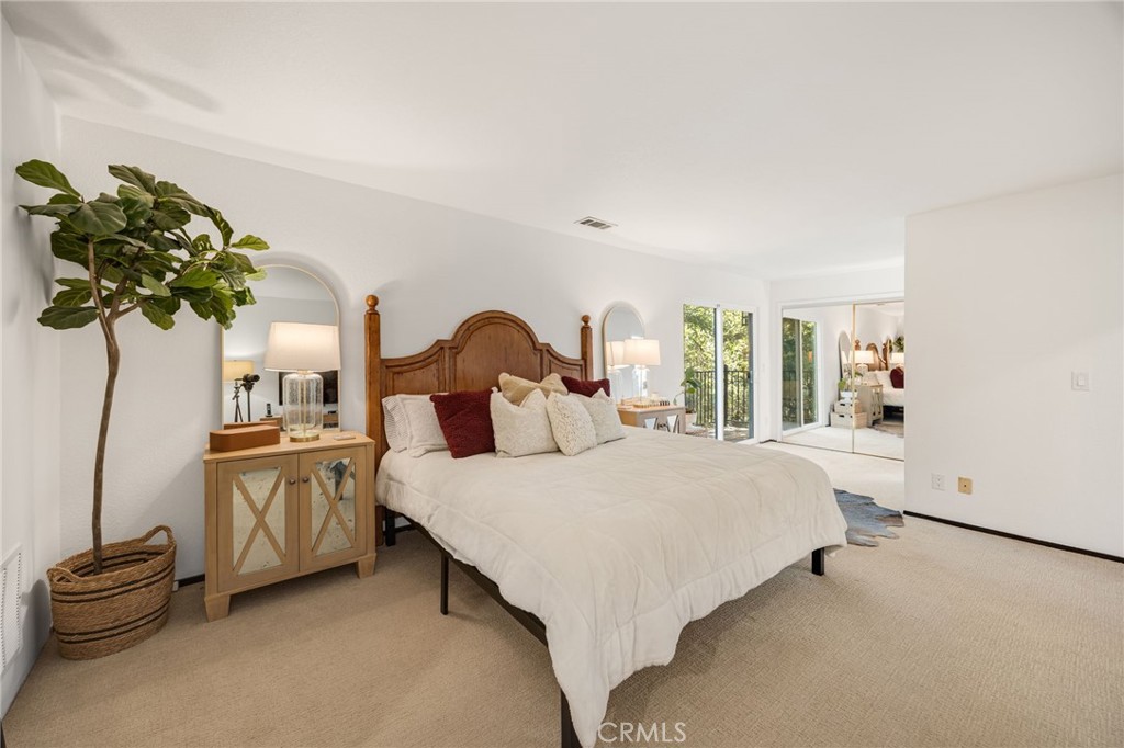 48980 De Luz Road Temecula, CA 92590 - Photo 32 of 50 a bedroom with a bed and a chandelier