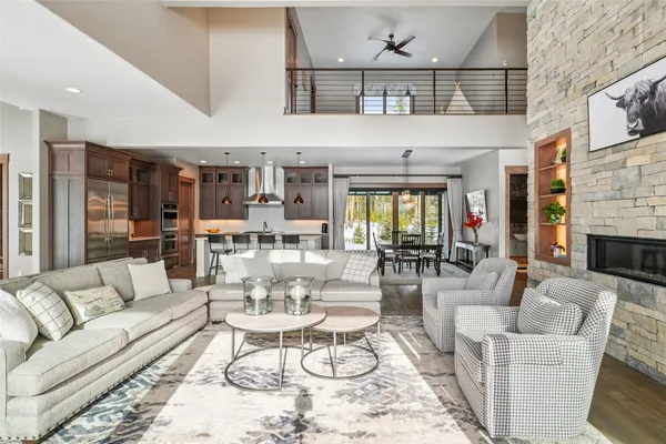 a large kitchen with kitchen island a large counter top space a sink and living room view