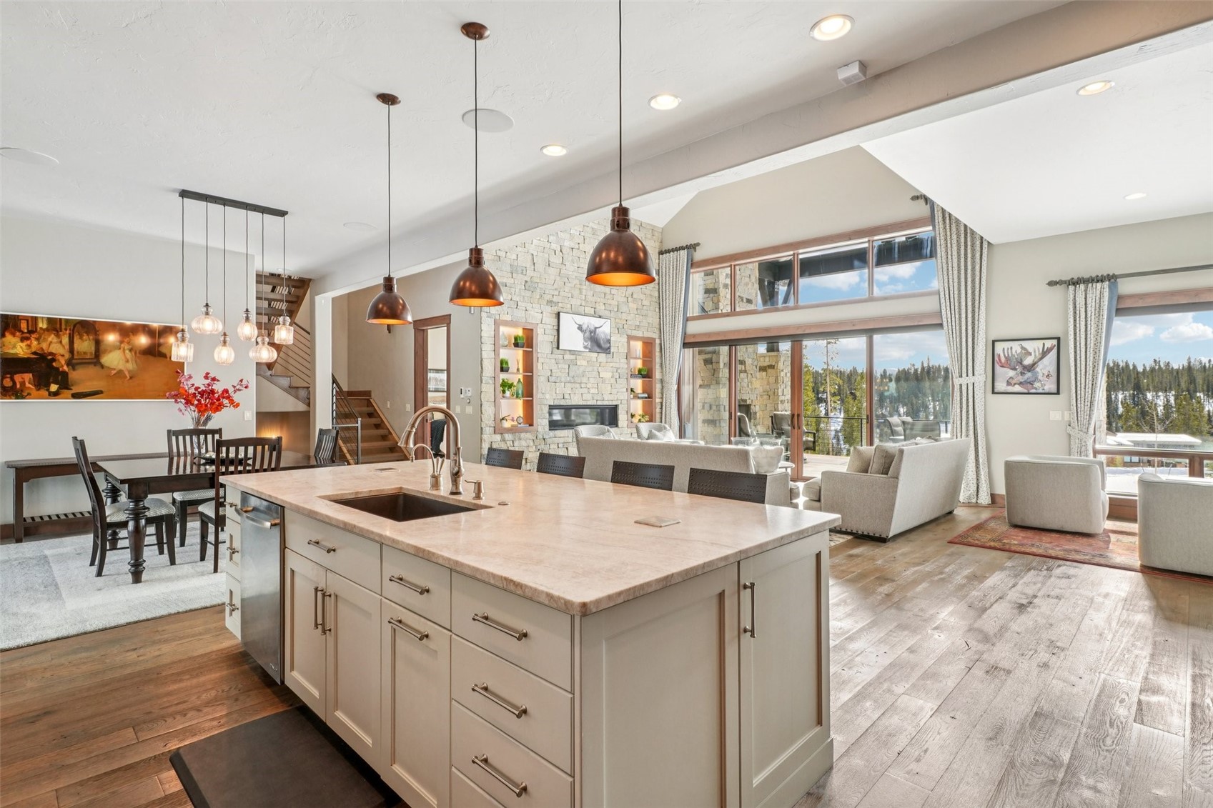60 Barton Ridge Drive Breckenridge, CO 80424 - Photo 15 of 50 Kitchen with open floor plan, light stone countertops, pendant lighting, dark wood-type flooring, and an island with sink