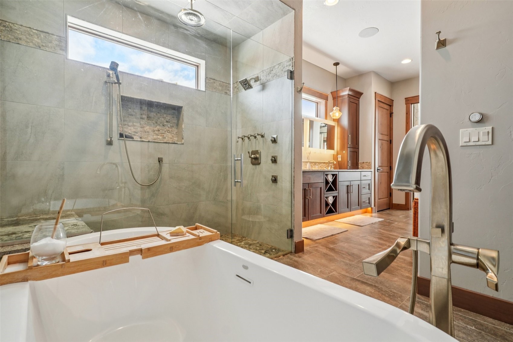 60 Barton Ridge Drive Breckenridge, CO 80424 - Photo 27 of 50 Bathroom with vanity, a stall shower, a soaking tub, and wood finished floors