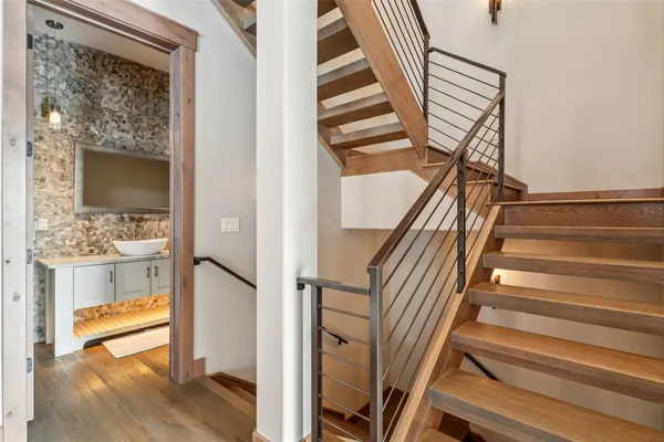 a view of entryway and hall with wooden floor