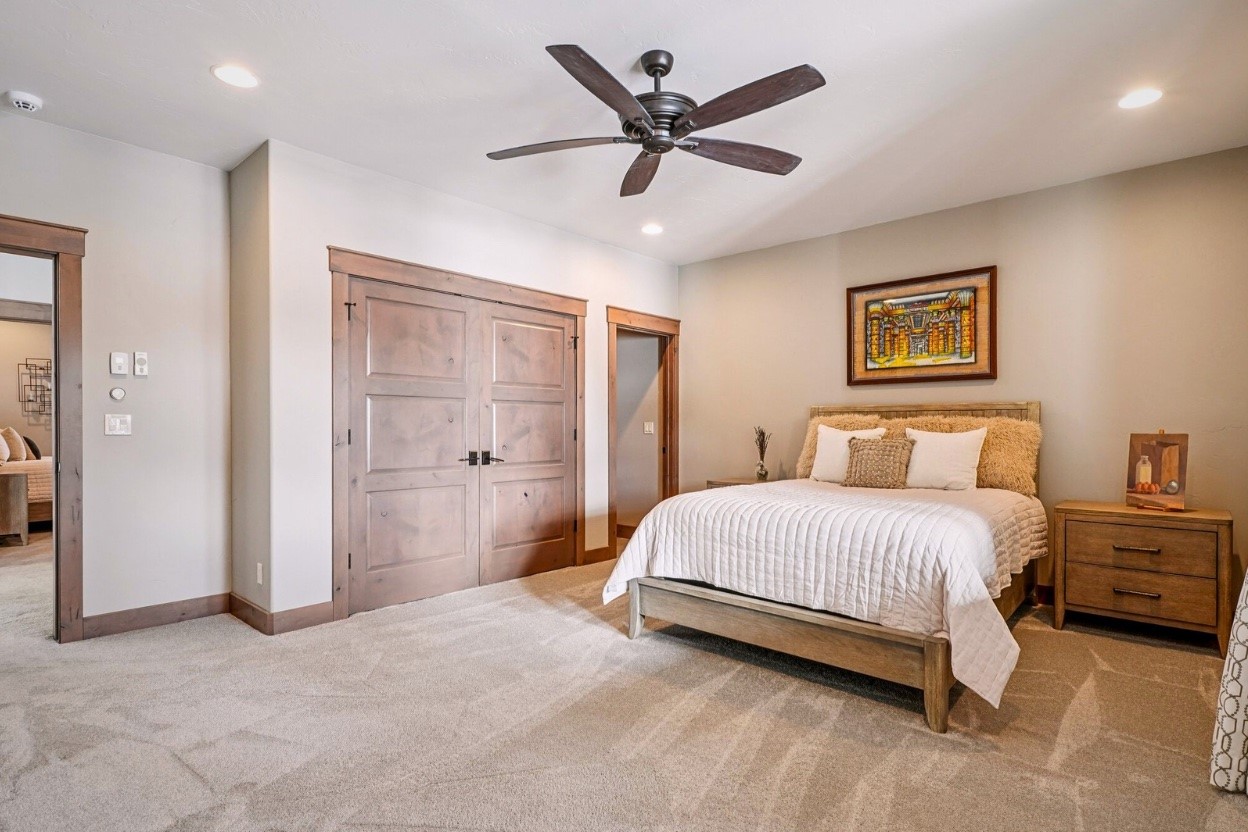 60 Barton Ridge Drive Breckenridge, CO 80424 - Photo 29 of 50 a spacious bedroom with a bed and a ceiling fan