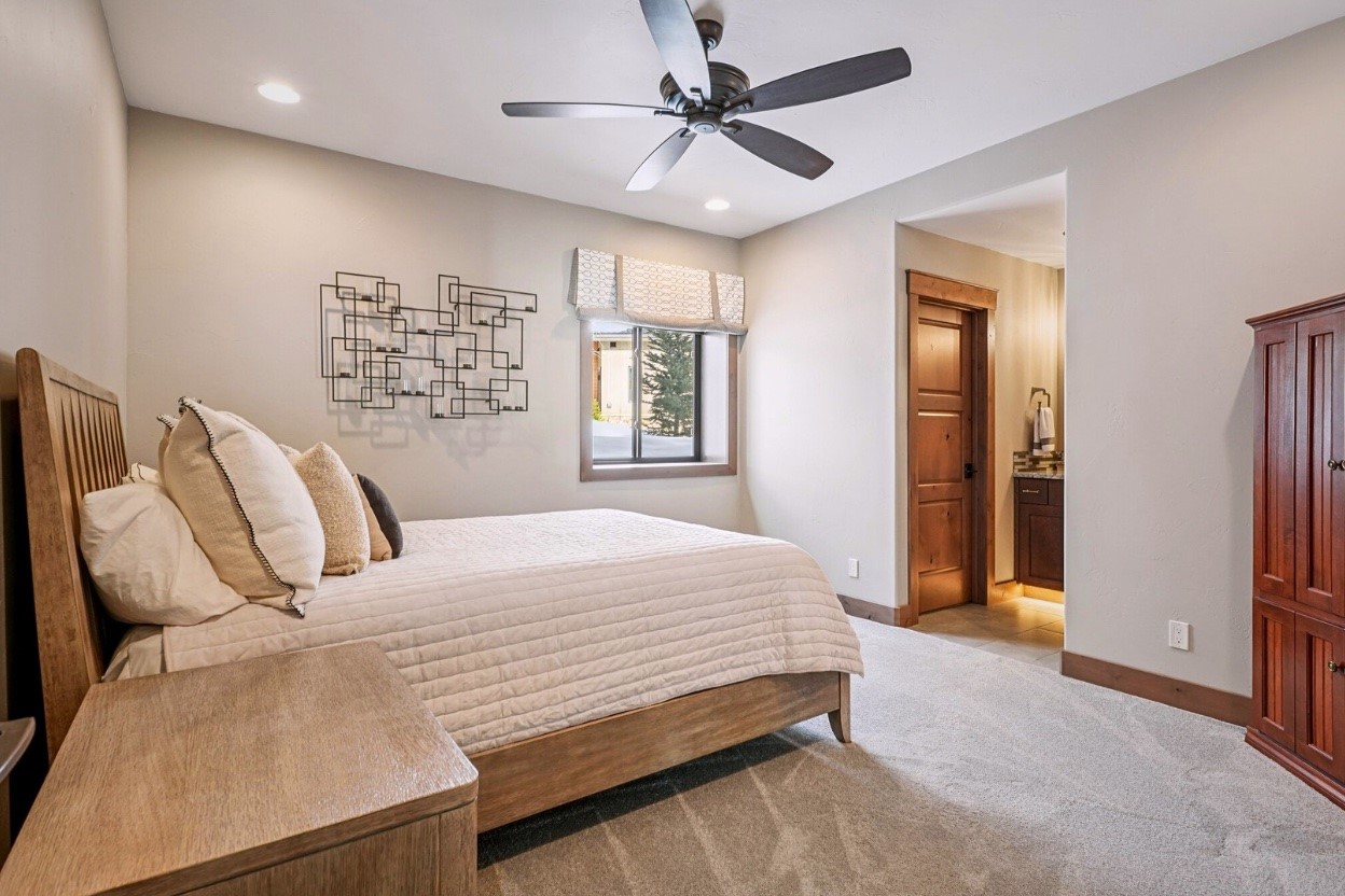 60 Barton Ridge Drive Breckenridge, CO 80424 - Photo 31 of 50 a bedroom with a large bed and a chandelier