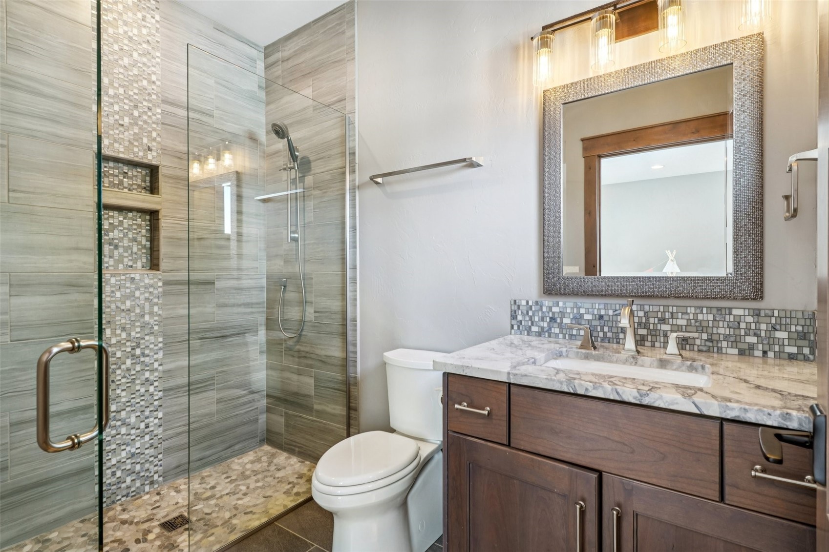 60 Barton Ridge Drive Breckenridge, CO 80424 - Photo 33 of 50 Bathroom with vanity, a shower stall, and decorative backsplash