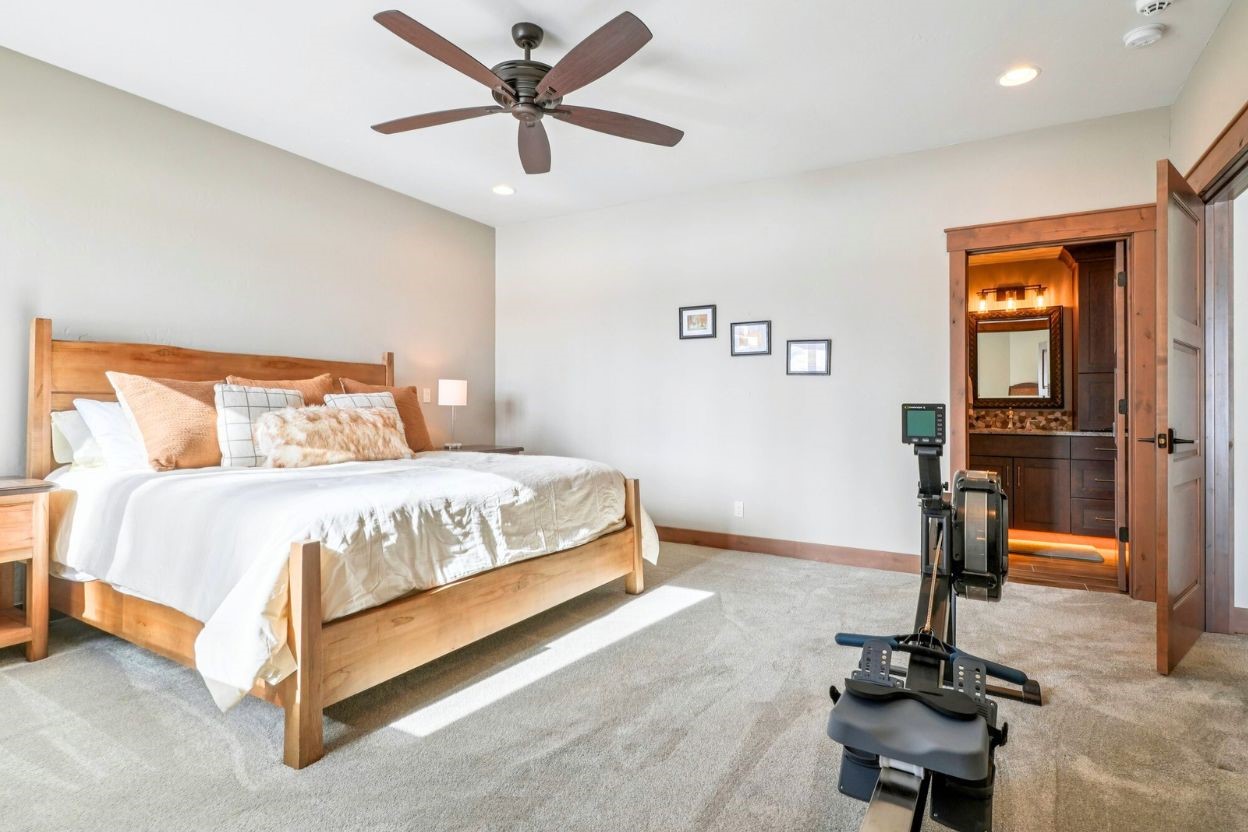 60 Barton Ridge Drive Breckenridge, CO 80424 - Photo 34 of 50 a bedroom with a bed and a chandelier