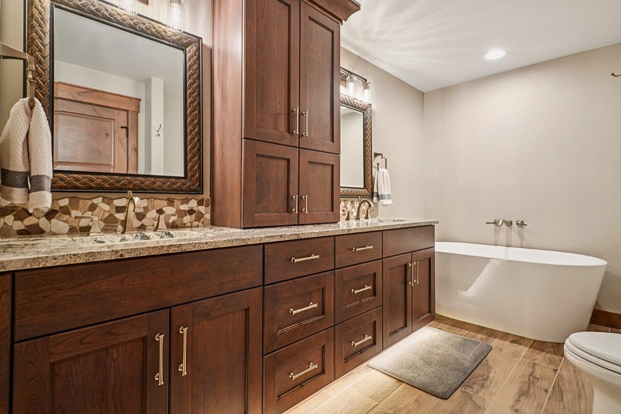 60 Barton Ridge Drive Breckenridge, CO 80424 - Photo 35 of 50 Bathroom with double vanity, a soaking tub, wood finish floors, tasteful backsplash, and recessed lighting