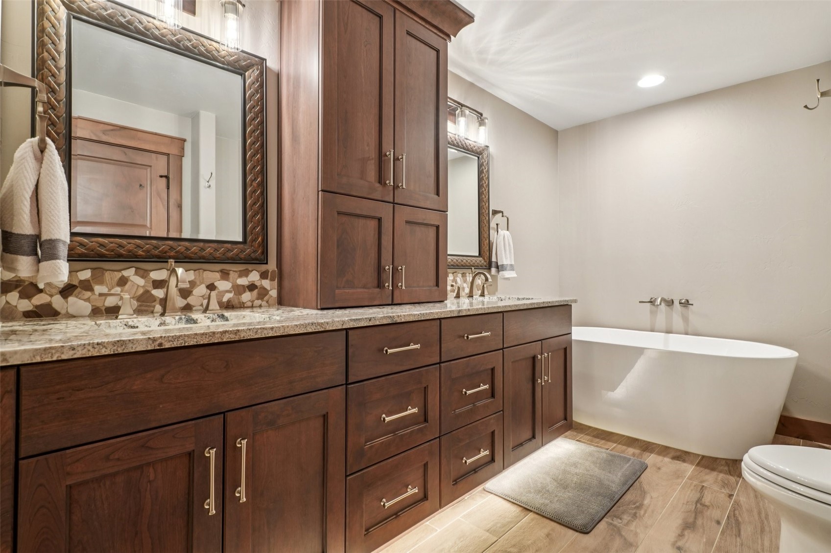 60 Barton Ridge Drive Breckenridge, CO 80424 - Photo 39 of 50 Full bathroom featuring double vanity, wood tiled floors, a freestanding bath, recessed lighting, and tasteful backsplash