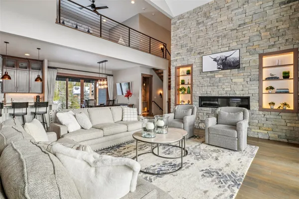 a living room with furniture fireplace and wooden floor