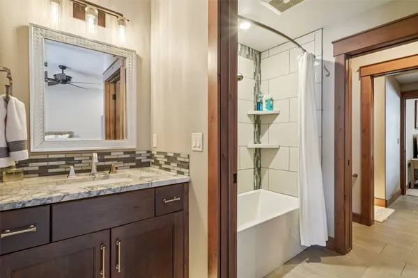 a view of a hallway with wooden floor and entryway