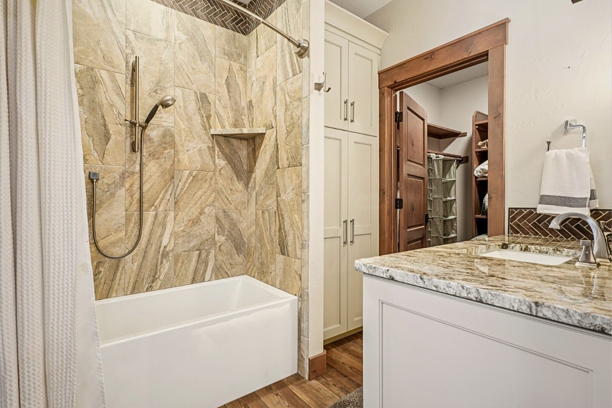 60 Barton Ridge Drive Breckenridge, CO 80424 - Photo 44 of 50 a bathroom with a granite countertop sink and a mirror