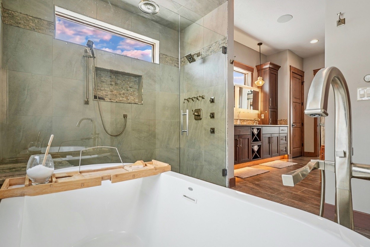 60 Barton Ridge Drive Breckenridge, CO 80424 - Photo 5 of 50 Primary bath with vanity, a shower stall, a freestanding bath, and dark wood-style floors