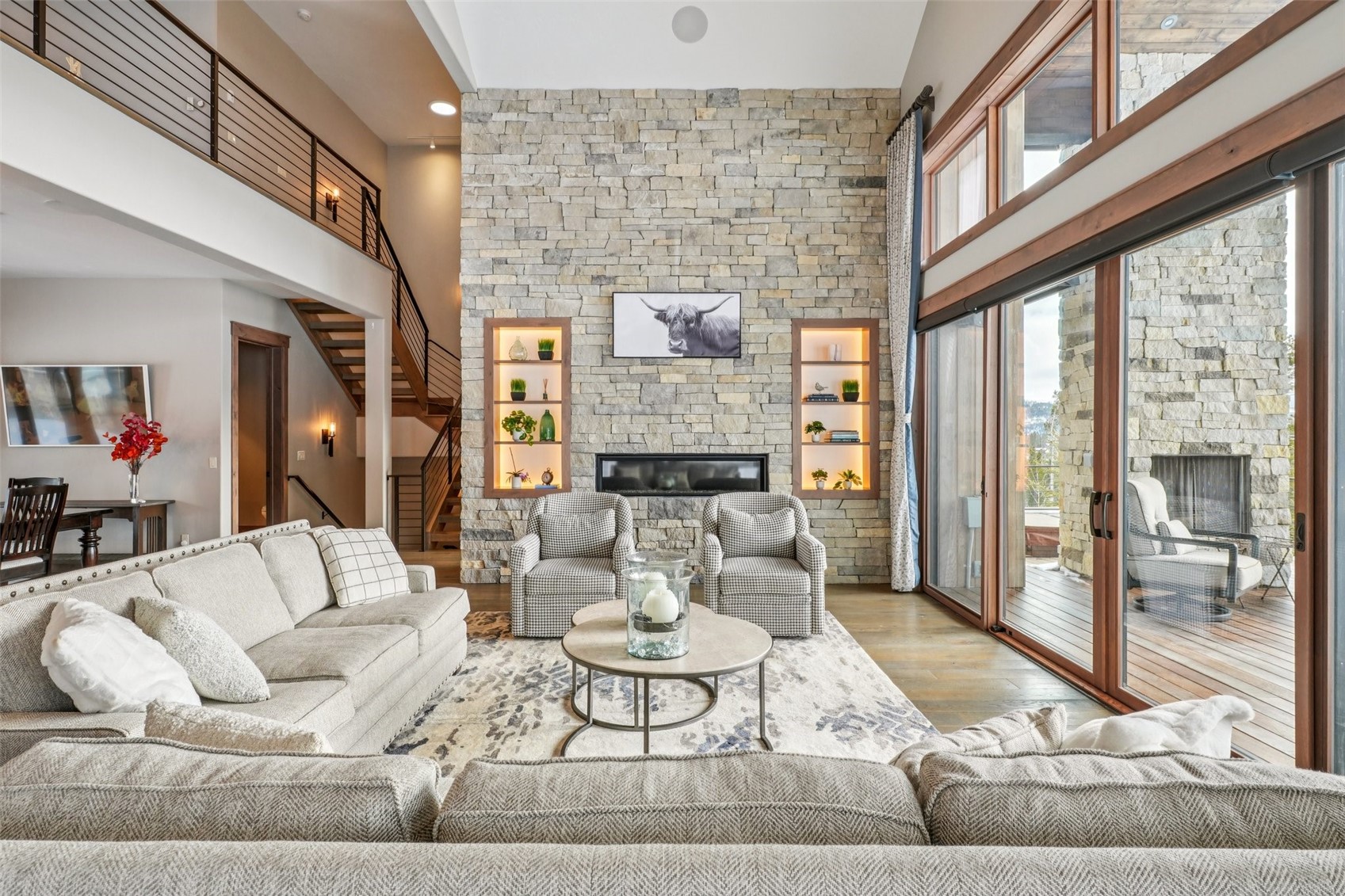 60 Barton Ridge Drive Breckenridge, CO 80424 - Photo 5 of 50 Living area with a stone fireplace, a high ceiling, and wood finished floors