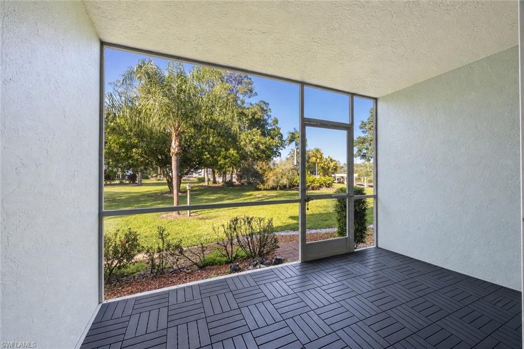 5737 Whitaker Road, Unit C101 Naples, FL 34112 - Photo 8 of 28 a view of an entryway with a garden