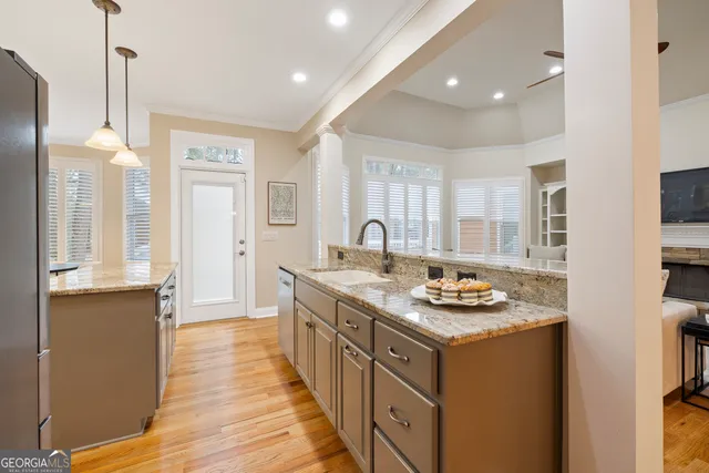 a kitchen with sink stove and cabinets