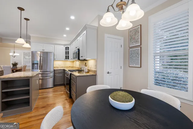 a large kitchen with a table and chairs