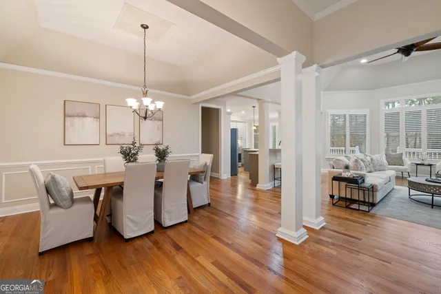 a view of a dining room with furniture wooden floor and chandelier