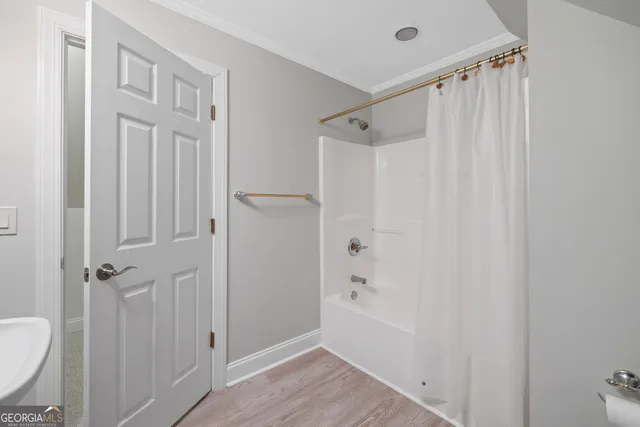 an empty room with a window and ceiling fan