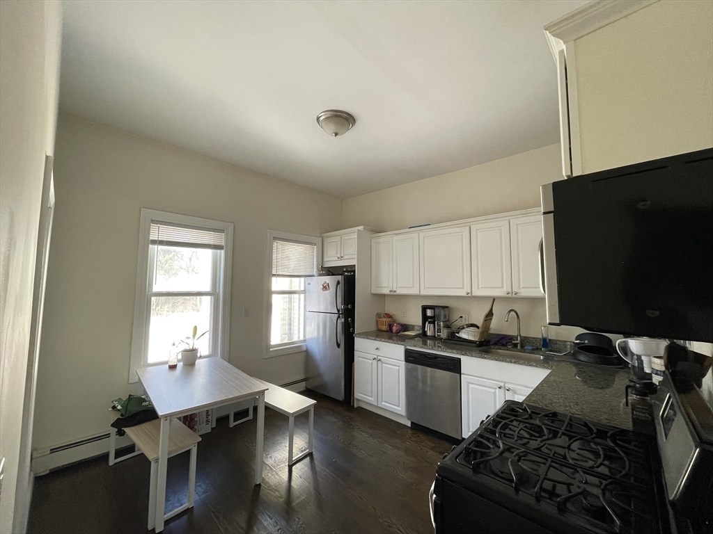 a kitchen with a sink appliances and cabinets
