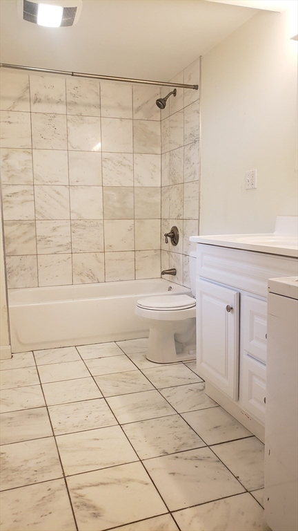 11 Seckel Street, Unit 1 Cambridge, MA 02141 - Photo 15 of 21 a bathroom with a toilet a sink and shower