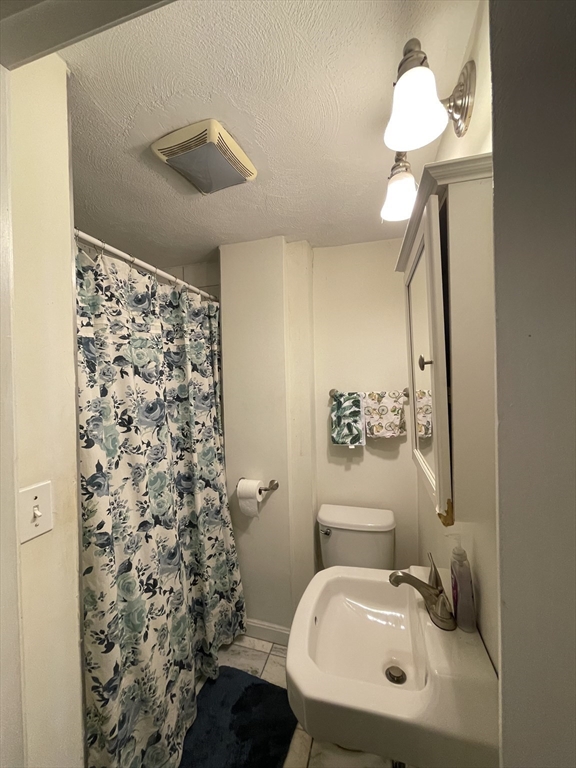 11 Seckel Street, Unit 1 Cambridge, MA 02141 - Photo 18 of 21 a bathroom with a sink toilet and a mirror