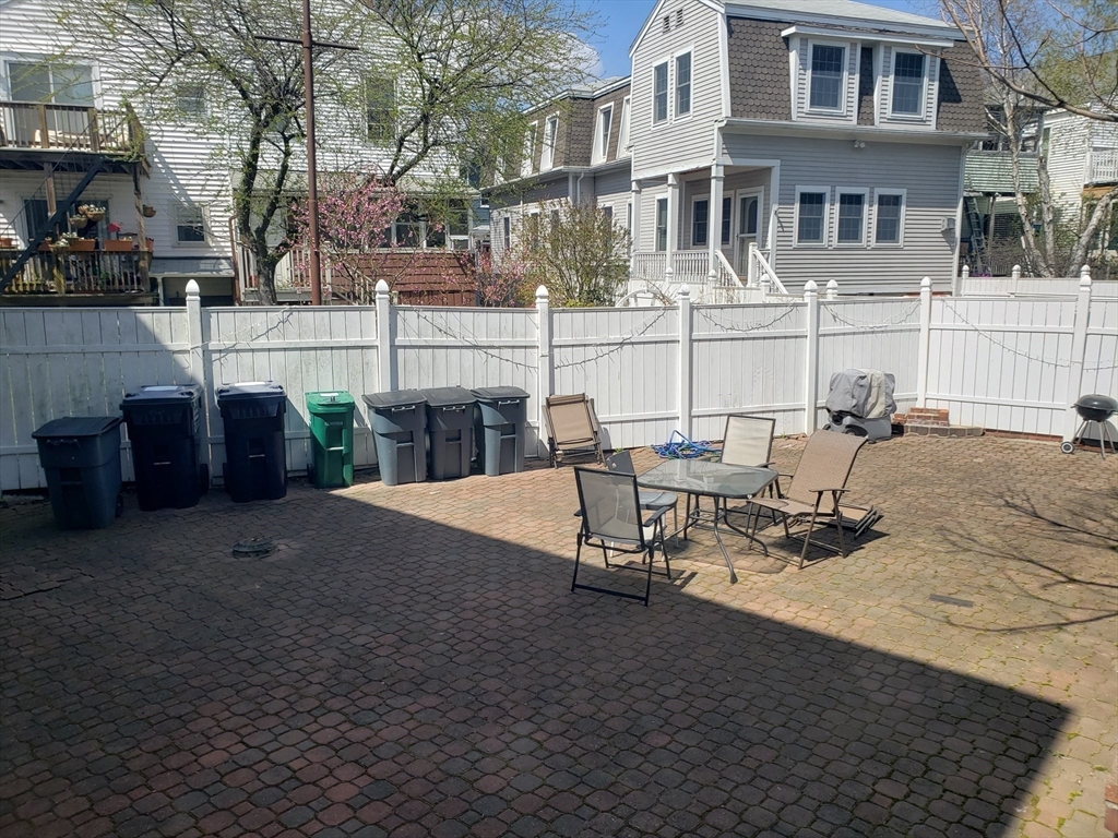 11 Seckel Street, Unit 1 Cambridge, MA 02141 - Photo 20 of 21 a view of a patio with table and chairs potted plants