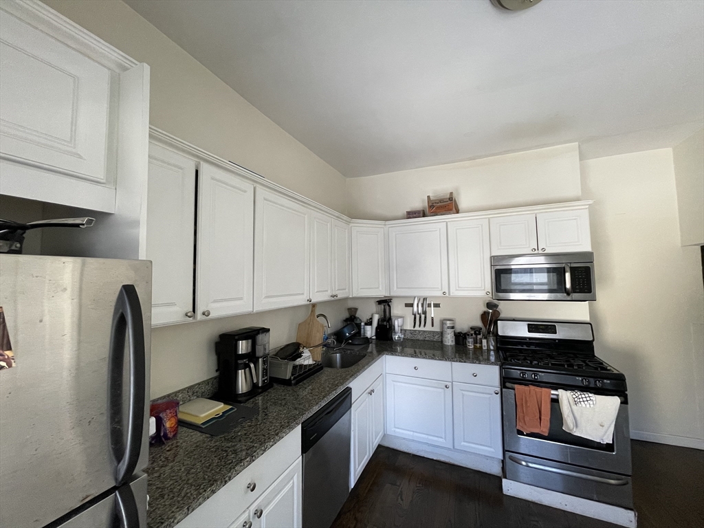 11 Seckel Street, Unit 1 Cambridge, MA 02141 - Photo 3 of 21 a kitchen with stainless steel appliances a stove refrigerator sink and cabinets