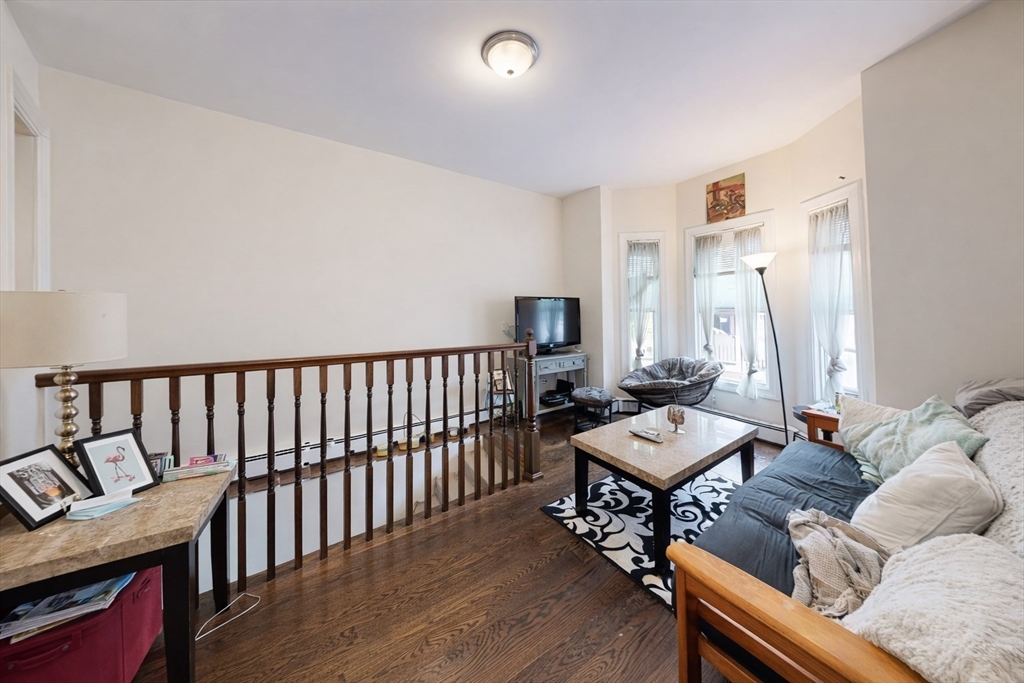 11 Seckel Street, Unit 1 Cambridge, MA 02141 - Photo 5 of 21 a living room with furniture and wooden floor