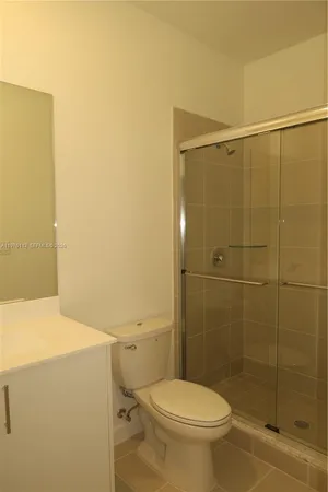 a bathroom with a toilet and a shower