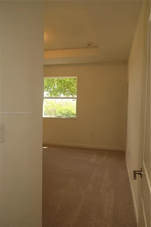 a view of an empty room and a window