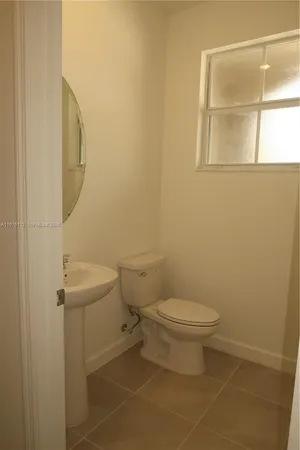 a white toilet sitting next to a bathroom sink