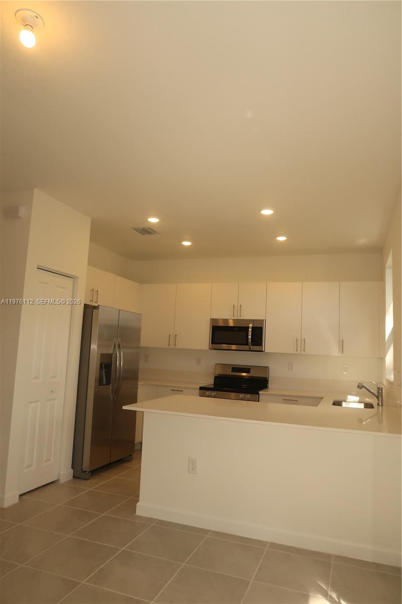 1509 Southeast 27th Street Homestead, FL 33035 - Photo 27 of 27 a view of kitchen with refrigerator sink and microwave