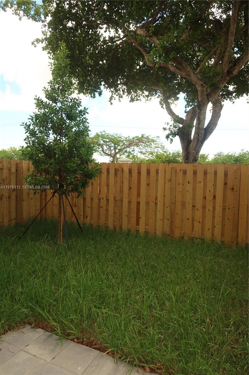 1509 Southeast 27th Street Homestead, FL 33035 - Photo 3 of 27 a backyard of a house with lots of green space and fountain