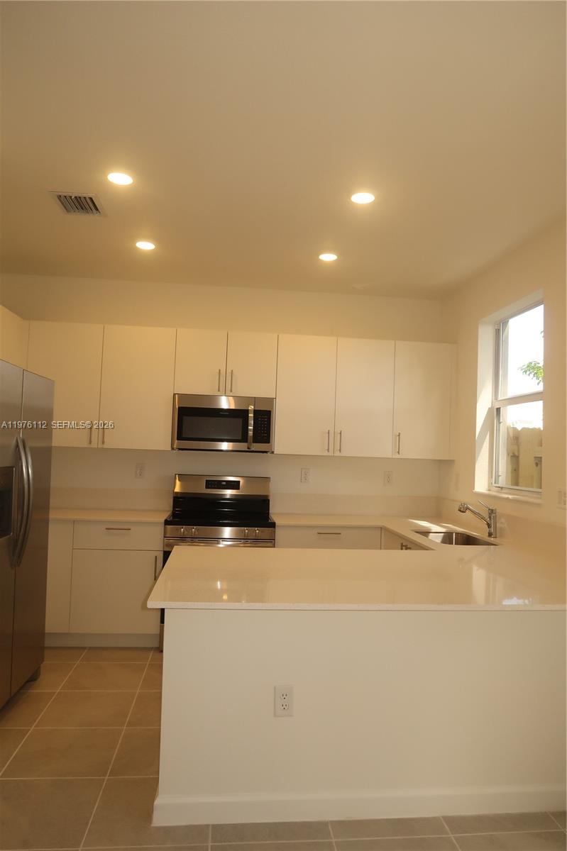 1509 Southeast 27th Street Homestead, FL 33035 - Photo 5 of 27 a room with a washing machine and a fireplace