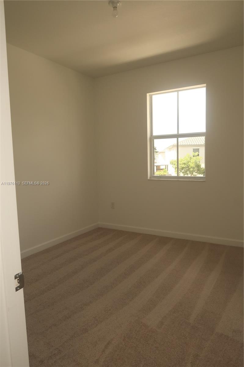 1509 Southeast 27th Street Homestead, FL 33035 - Photo 7 of 27 an empty room with a window