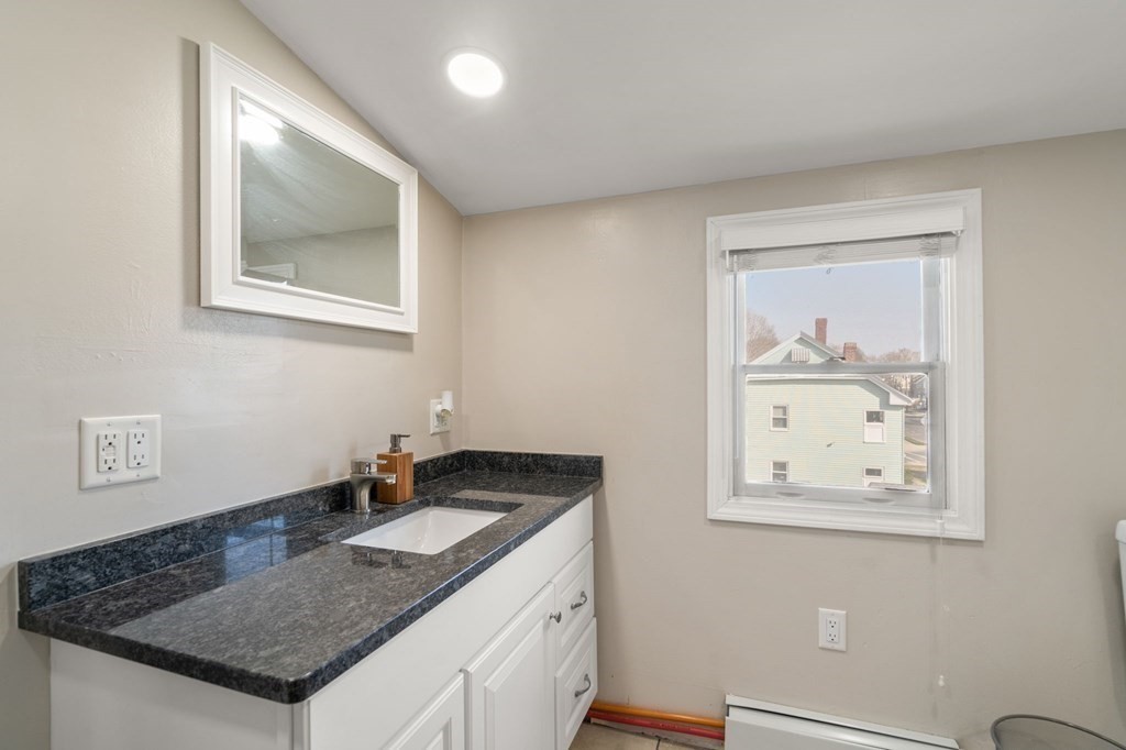 83 Cedar Street Wakefield, MA 01880 - Photo 12 of 36 a bathroom with a granite countertop sink and a window